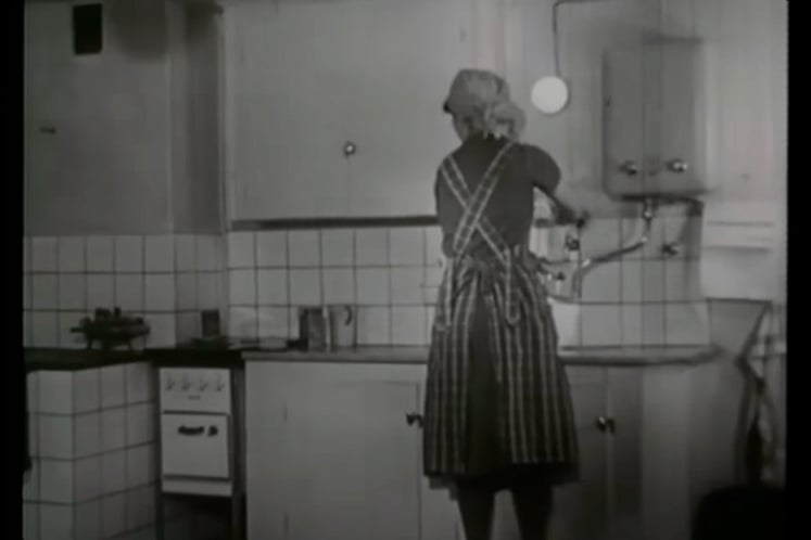 Woman in a kitchen - screengrab from the video about electricity promotion in the 40s
