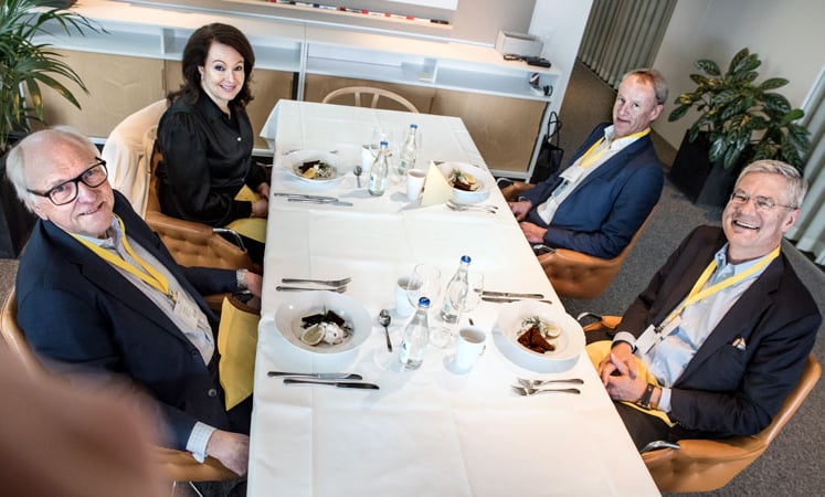 Four CEOs seated around the table for lunch